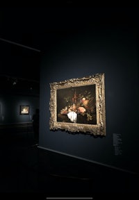 a painting is on display in a dark room